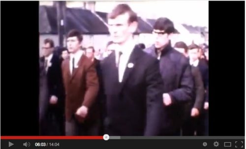 Is this Gerry Adams, wearing classes, on the right?