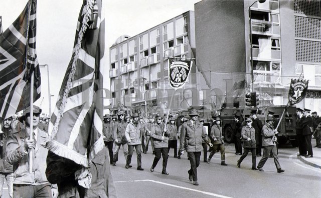 The UDA, at the height of their power in 1972, parade past the Nationalist Unity Flats